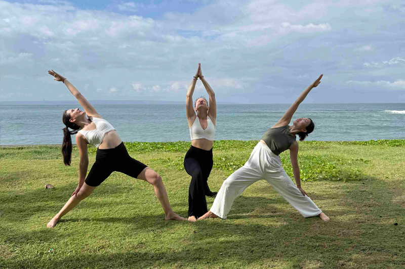 Students in a deep relaxation state during a Yoga Nidra session with singing bowls for corporate stress management.